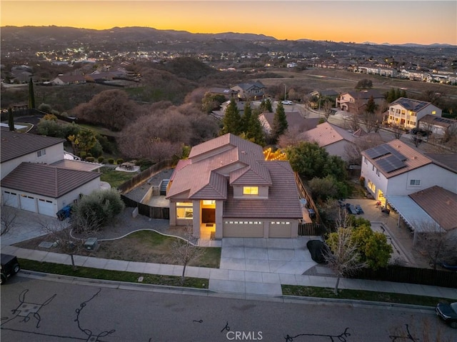 aerial view at dusk featuring a mountain view