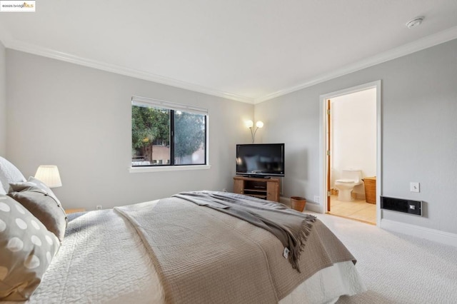 carpeted bedroom with crown molding and ensuite bath