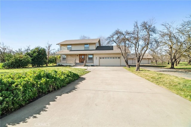 view of front facade featuring a front yard and a garage