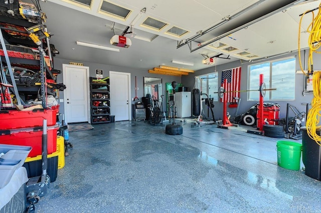 garage with white fridge and a garage door opener