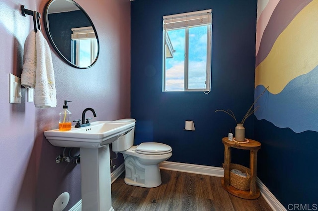 bathroom with toilet and hardwood / wood-style floors