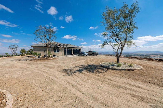 ranch-style home with a garage and a mountain view