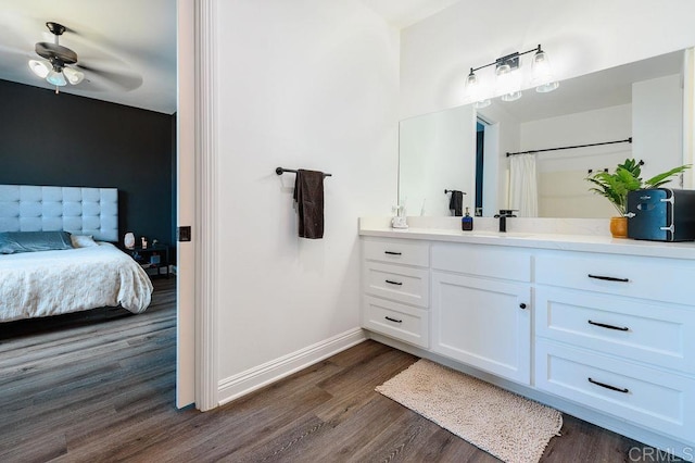 bathroom with ceiling fan, a shower with curtain, hardwood / wood-style floors, and vanity