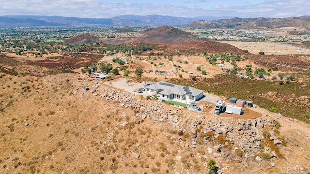 birds eye view of property with a mountain view