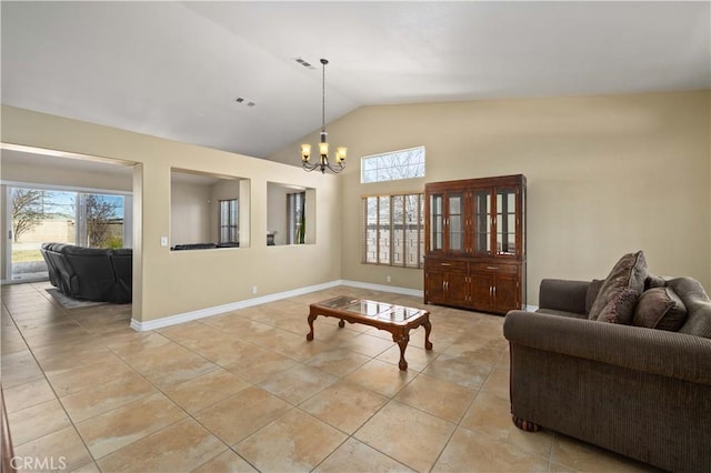 living room with light tile patterned flooring, a chandelier, and vaulted ceiling