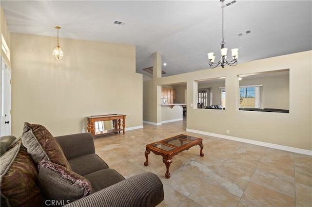 living room featuring lofted ceiling and a notable chandelier