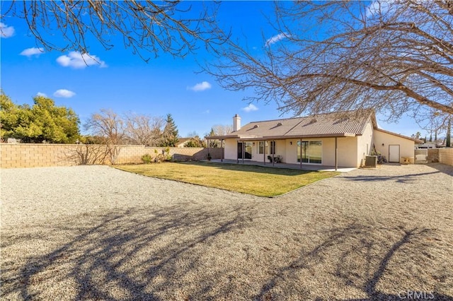 back of property featuring a lawn and a patio