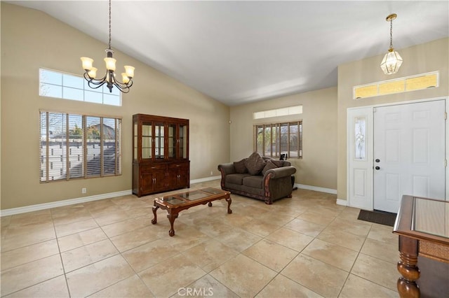 foyer featuring light tile patterned floors, high vaulted ceiling, and a notable chandelier