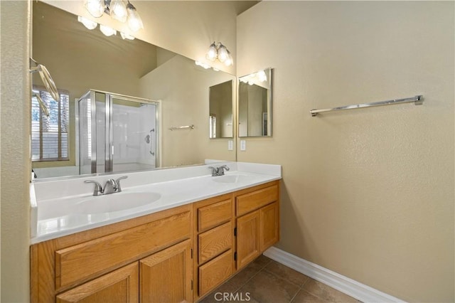 bathroom with vanity, tile patterned flooring, and a shower with door