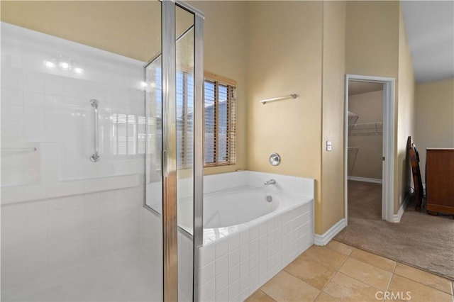 bathroom featuring tile patterned flooring and separate shower and tub