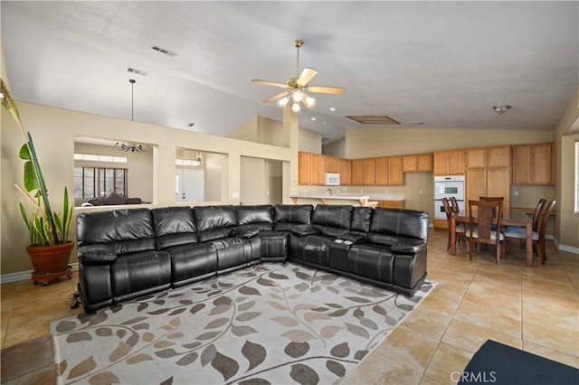 living room featuring ceiling fan, light tile patterned floors, and high vaulted ceiling