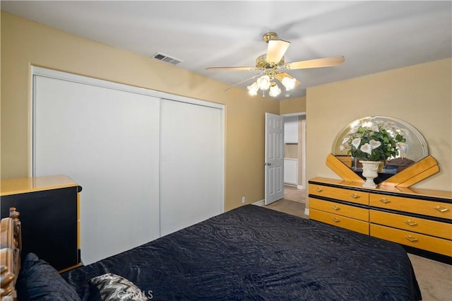 unfurnished bedroom featuring ceiling fan, a closet, and light carpet