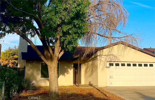 44504 Watford Ave, Lancaster, CA 93535 - ranch-style house with stucco siding, a garage, and concrete driveway