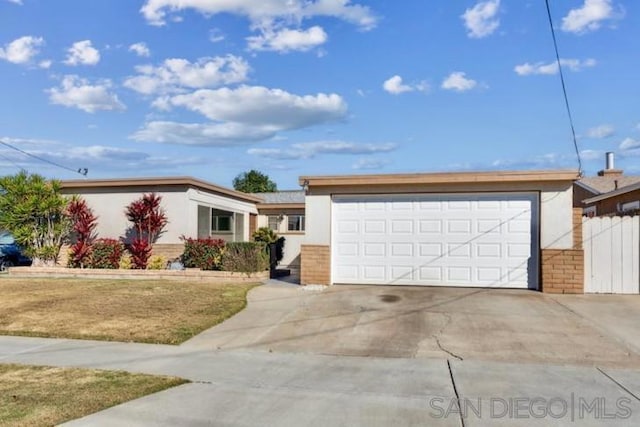 single story home with a front yard and a garage