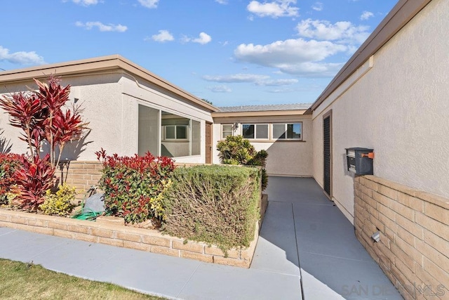 entrance to property with a patio