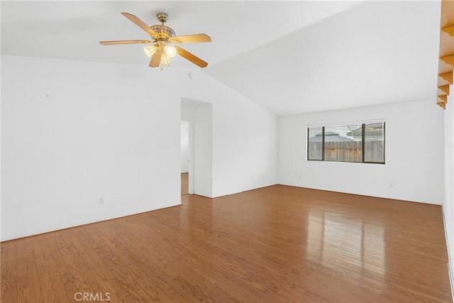 spare room with a ceiling fan, lofted ceiling, and wood finished floors