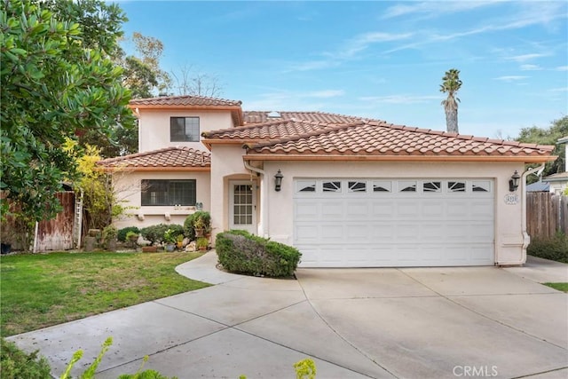 mediterranean / spanish-style house featuring concrete driveway, a tile roof, an attached garage, fence, and stucco siding