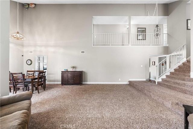 44028 Halcom Ave, Lancaster, CA 93536 - living room featuring a high ceiling, carpet, and a chandelier