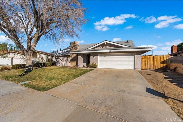 ranch-style house with a front yard and a garage