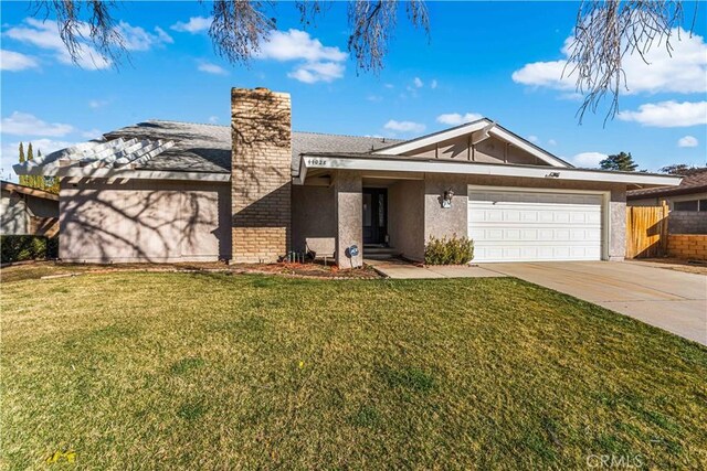 view of front of home with a front lawn and a garage