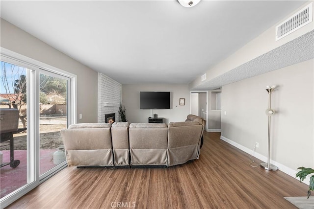 44028 Halcom Ave, Lancaster, CA 93536 - living room with a brick fireplace and hardwood / wood-style flooring