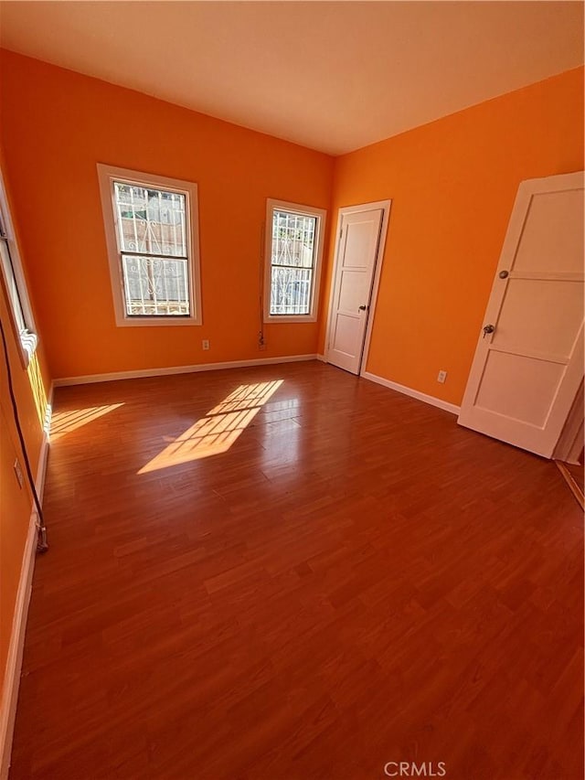 empty room with hardwood / wood-style floors