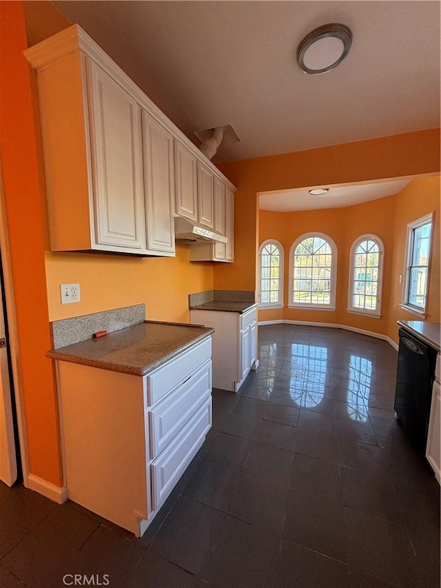 kitchen featuring white cabinetry and dishwasher