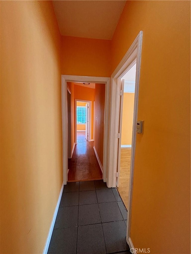 hallway with tile patterned floors