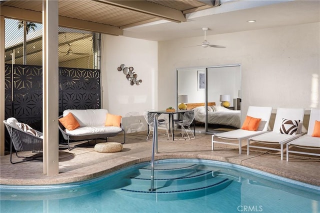 view of swimming pool featuring ceiling fan