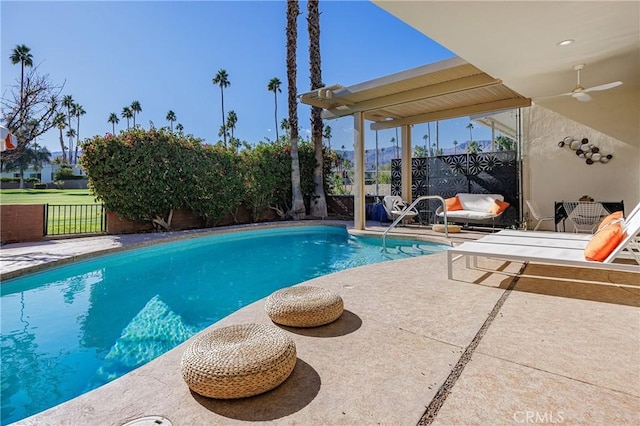 view of swimming pool with ceiling fan and a patio