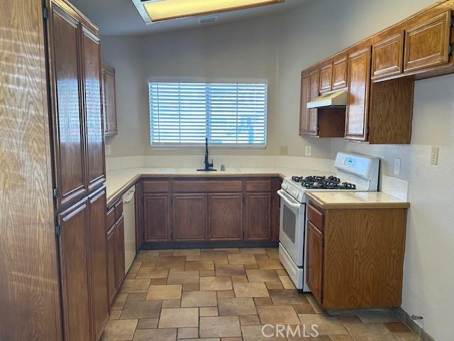 kitchen featuring sink and white appliances