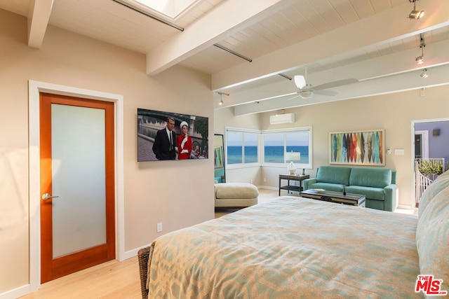 bedroom with ceiling fan, beamed ceiling, light hardwood / wood-style flooring, a water view, and rail lighting