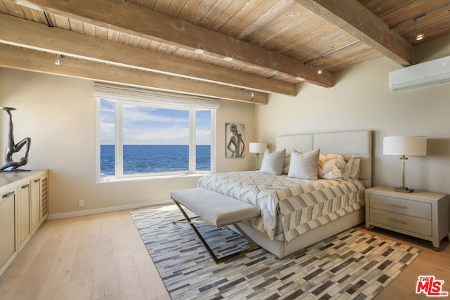 bedroom with an AC wall unit, beamed ceiling, light hardwood / wood-style flooring, a water view, and wooden ceiling