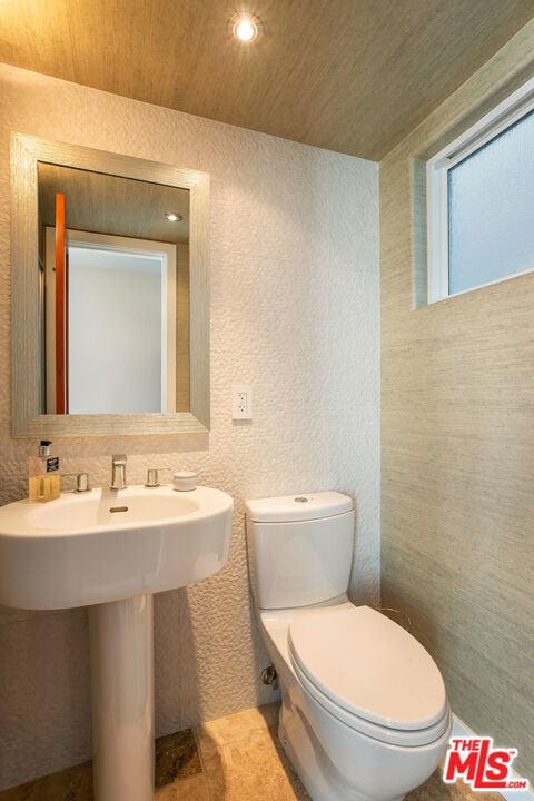 bathroom with toilet and wooden ceiling