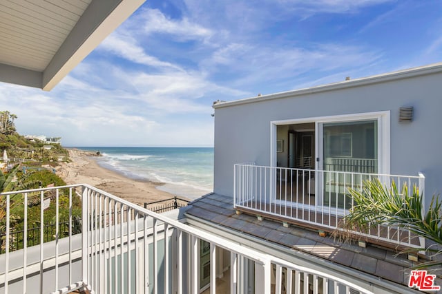 balcony with a beach view and a water view