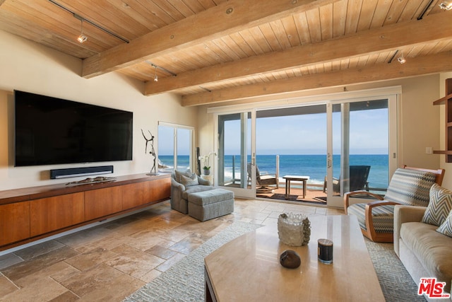 living room featuring a water view, beam ceiling, wooden ceiling, and rail lighting