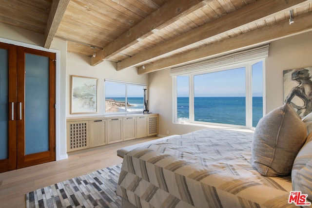 bedroom featuring a water view, beam ceiling, wood ceiling, and light hardwood / wood-style floors