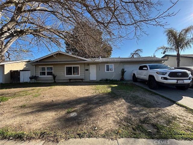 single story home featuring a front lawn and a garage