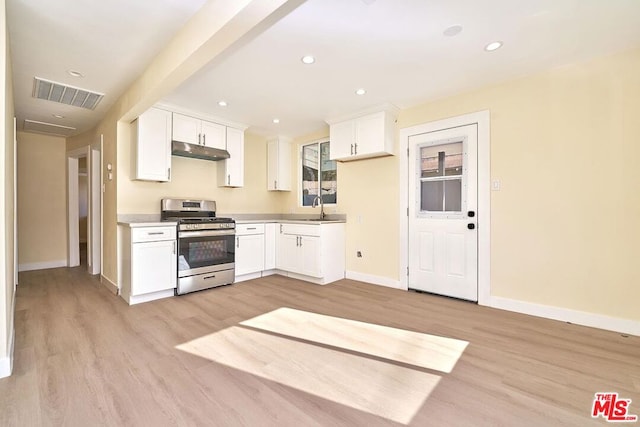 kitchen featuring white cabinets, sink, gas stove, and light hardwood / wood-style floors