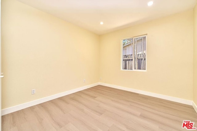 unfurnished room with light hardwood / wood-style floors