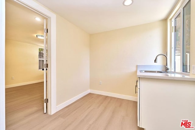 interior space with light wood-type flooring and sink