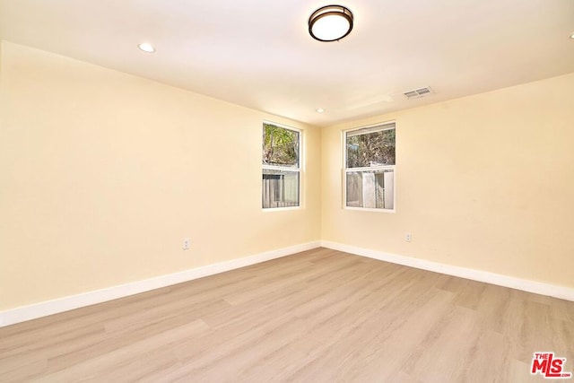 spare room with light hardwood / wood-style flooring