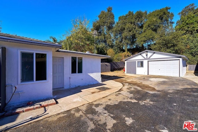 view of home's exterior featuring a garage and an outbuilding