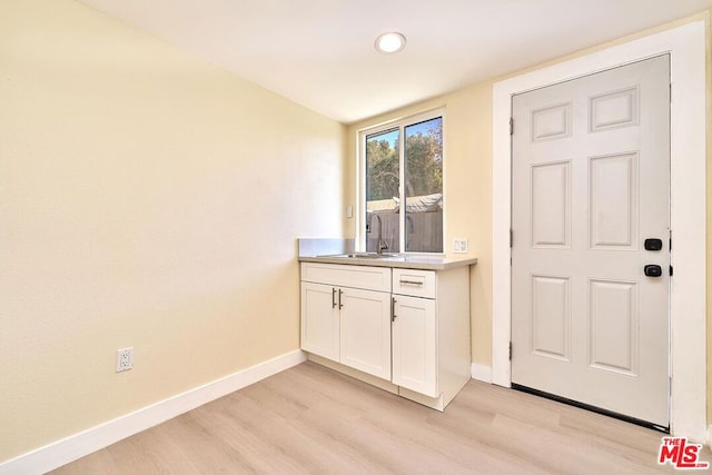 interior space featuring sink and light hardwood / wood-style flooring