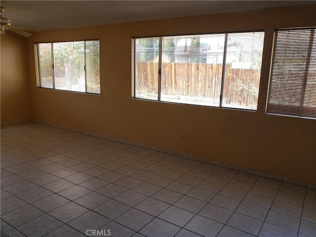 unfurnished room featuring ceiling fan and light tile patterned floors