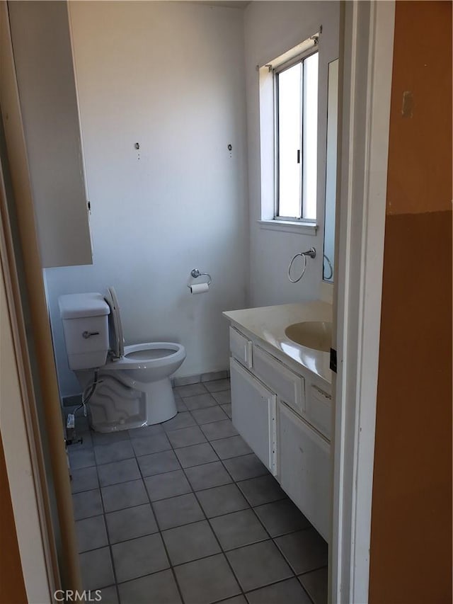 bathroom featuring tile patterned floors, vanity, and toilet