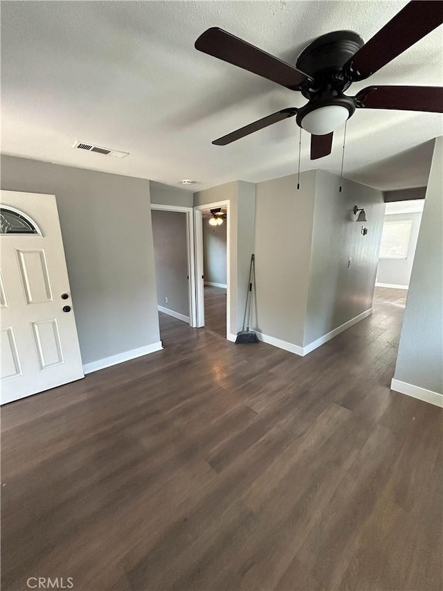 empty room featuring ceiling fan and dark hardwood / wood-style floors