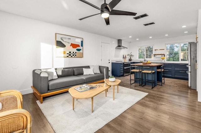 living room featuring ceiling fan and light wood-type flooring