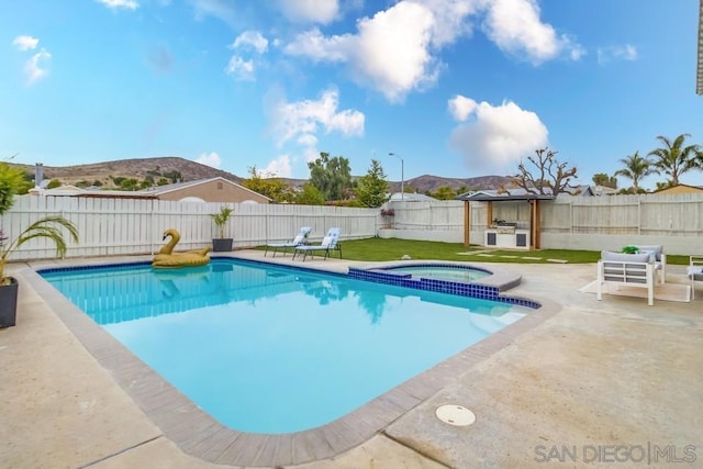 view of pool featuring area for grilling, a mountain view, an in ground hot tub, and a patio