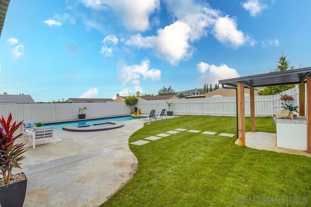 view of yard with a fenced in pool and a patio area